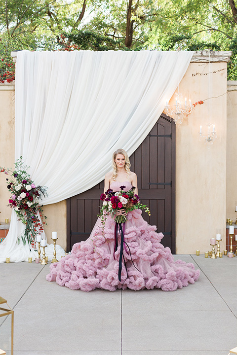 Los angeles valentine theme wedding shoot at the gardens at los robles bride pink ballgown dress with ruffled skirt and dark pink and white floral bridal bouquet