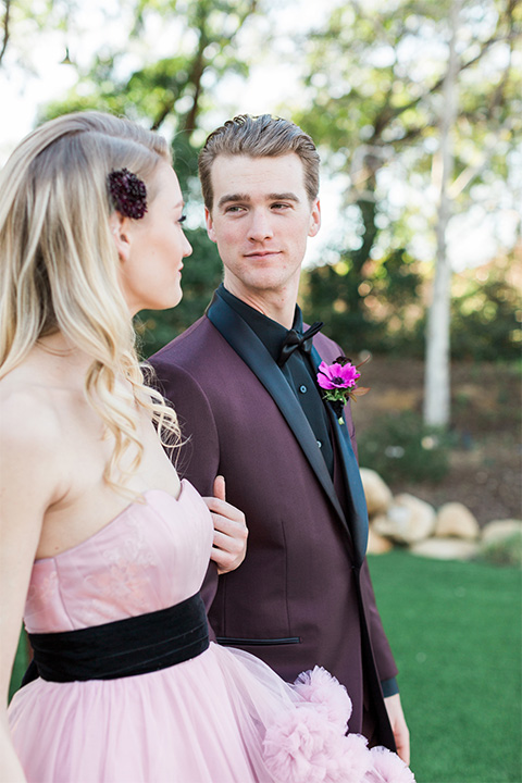 Los angeles valentine theme wedding shoot at the gardens at los robles bride pink ballgown dress with ruffled skirt and dark pink and white floral bridal bouquet with groom burgundy tuxedo with black dress shirt and black bow tie with red floral boutonniere