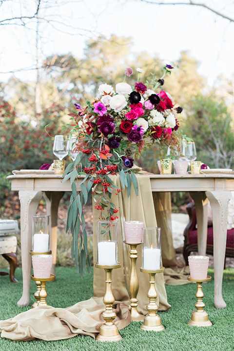 Los angeles valentine theme wedding shoot at the gardens at los robles vintage red and white lounge furniture with table and flower deocr and white and gold place settings with gold silverware and white candle decor