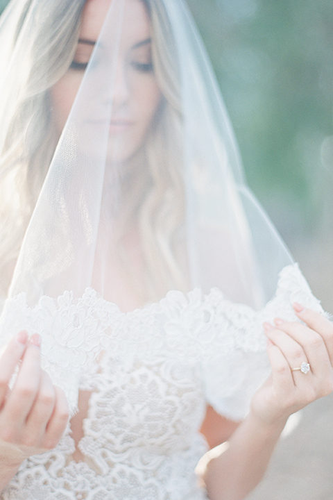Into the woods outdoor romantic wedding shoot bride chiffon gown with thin spahetti straps and strap design on back with lace detail and sweetheart neckline under veil