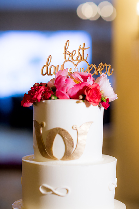San diego wedding at the crossings carlsbad two tier white wedding cake with gold decor and gold calligraphy cake topper with white and pink flower decor on top wedding photo idea for cake