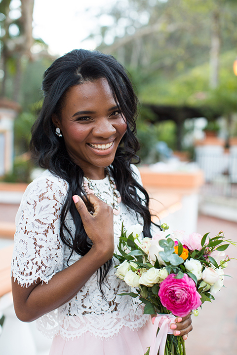 Rancho las lomas outdoor engagement shoot bride light pink tulle skirt with a white lace short sleeve top holding white and pink floral bridal bouquet smiling and laughing