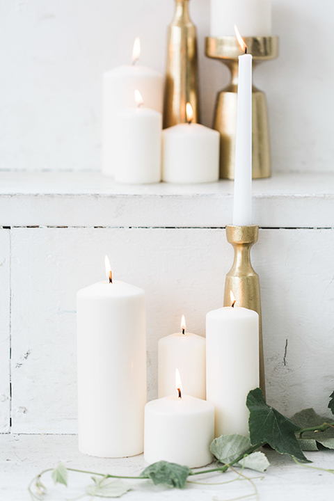 Downtown los angeles wedding shoot at fd photo studio table set up with grey table linen and white and green flower decor with clear ghost chairs and white and grey place settings with white candle decor and piano